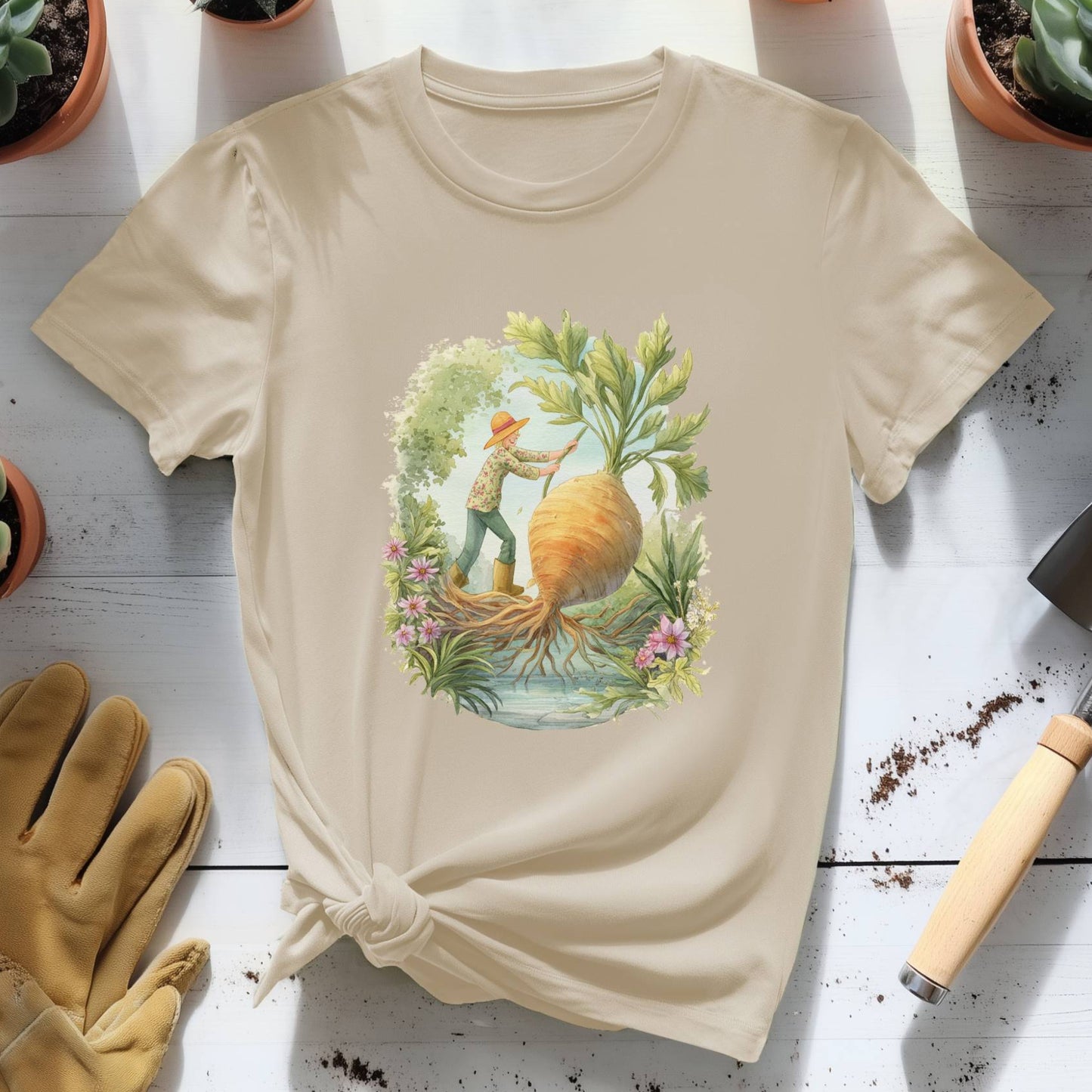 Beige t-shirt with a graphic design of a person gardening, surrounded by potted plants and gardening tools on a wooden surface.