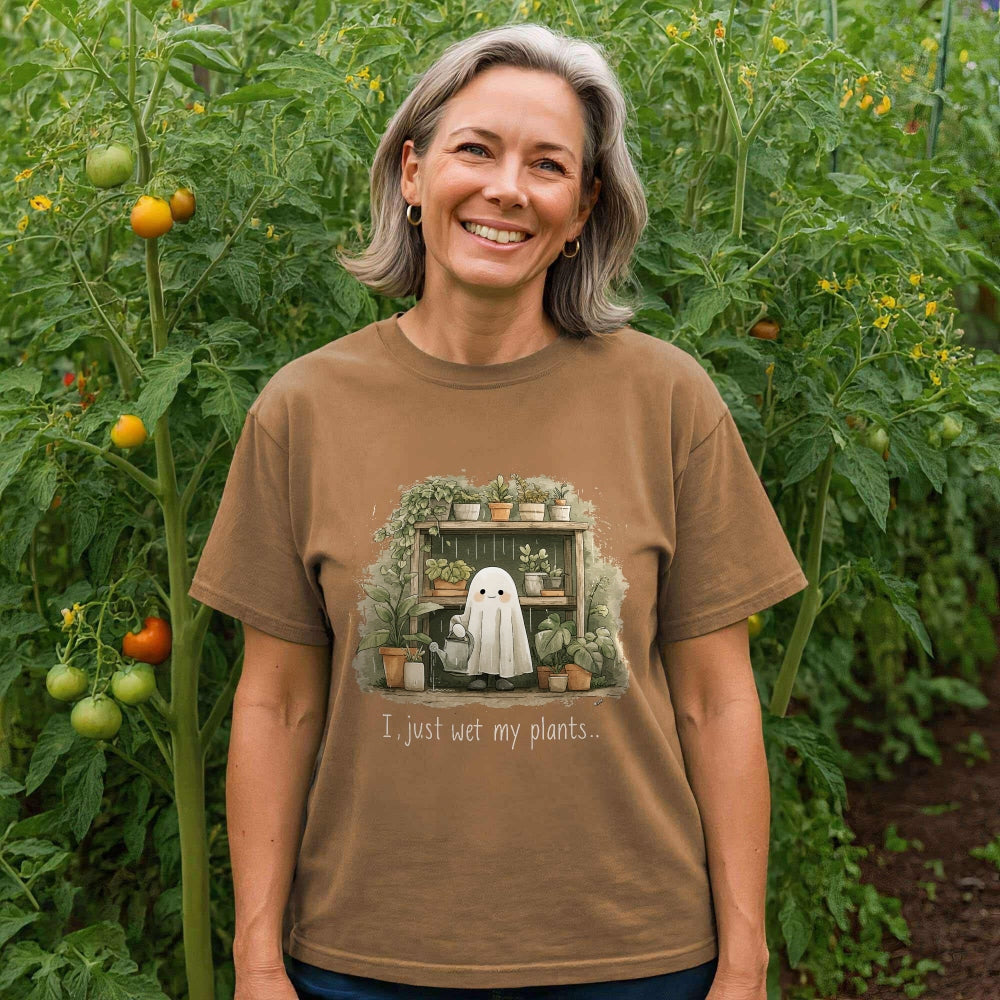 Woman wearing a brown t-shirt with a plant-themed graphic in a garden.