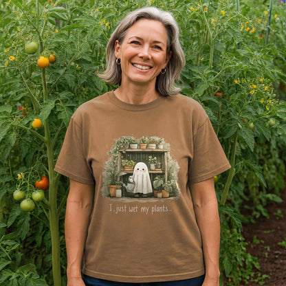 Woman wearing a brown t-shirt with a plant-themed graphic in a garden.